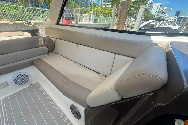 Slide: The Image of Interior seating of a 2015 Regal 35 Sport Coupe boat at a marina. - 23