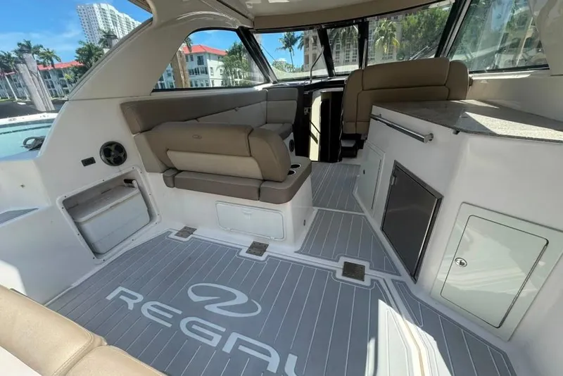 Slide: The Image of 2015 Regal 35 Sport Coupe interior with beige seating and modern amenities. - 26