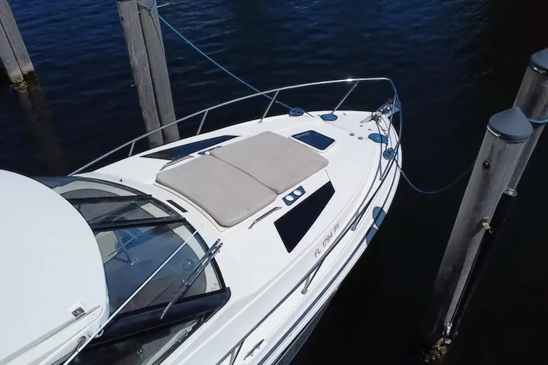 Slide: The Image of 2015 Regal 35 Sport Coupe docked, featuring sleek design and sunbathing area. - 14