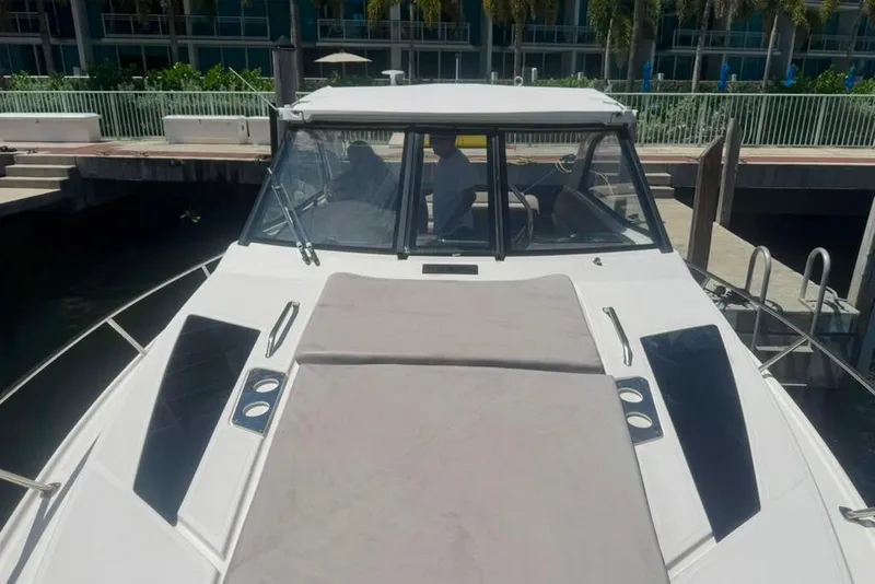 Slide: The Image of 2015 Regal 35 Sport Coupe docked, showcasing sleek design and spacious deck. - 15