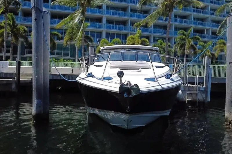 Slide: The Image of 2015 Regal 35 Sport Coupe docked near palm trees and modern building. - 13