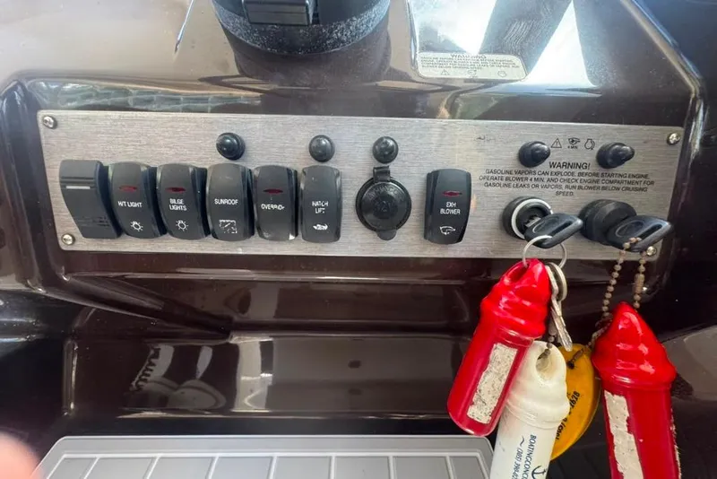 Slide: The Image of Control panel of a 2015 Regal 35 Sport Coupe with labeled switches and warning signs. - 80