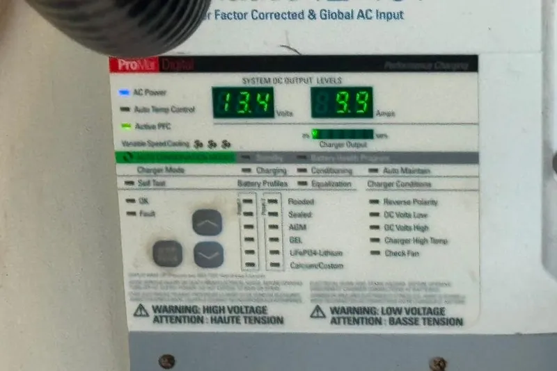 Slide: The Image of Control panel display showing voltage and amperage readings on a 2015 Regal 35 Sport Coupe. - 82