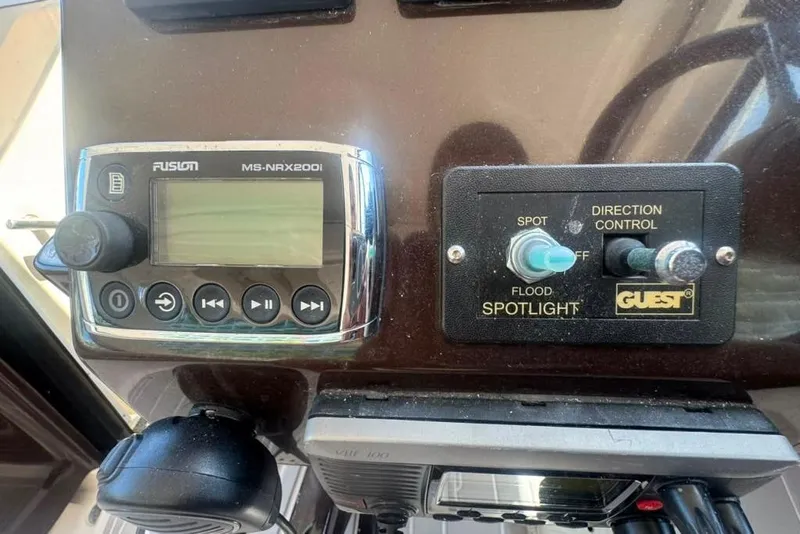 Slide: The Image of Control panel of a 2015 Regal 35 Sport Coupe with audio and spotlight controls. - 76