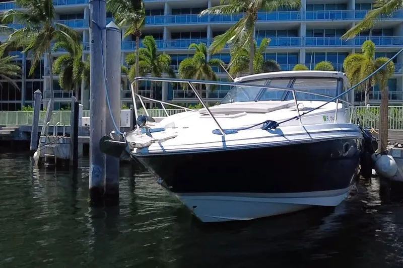Slide: The Image of 2015 Regal 35 Sport Coupe docked near palm trees and modern building. - 18
