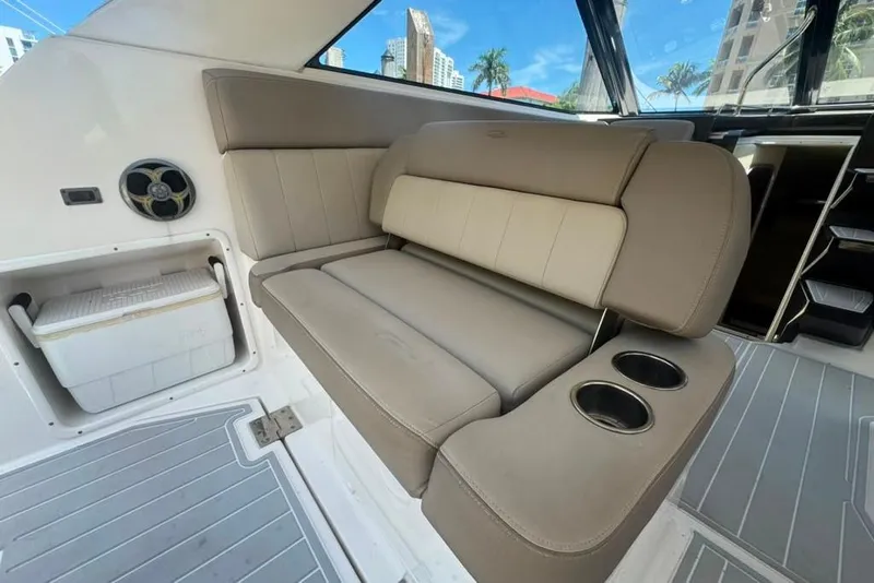 Slide: The Image of Interior of 2015 Regal 35 Sport Coupe with beige seating and cup holders. - 28