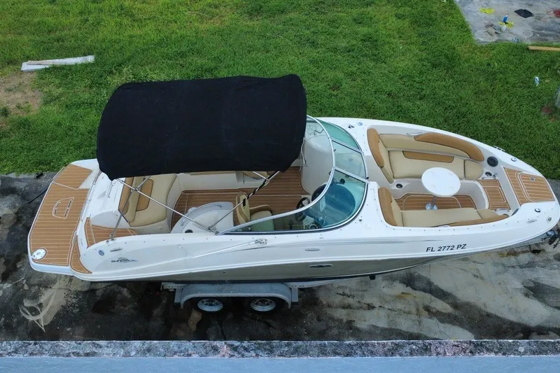 Slide: The Image of 2007 Sea Ray 260 Sundeck boat with canopy, parked on trailer, aerial view. - 2