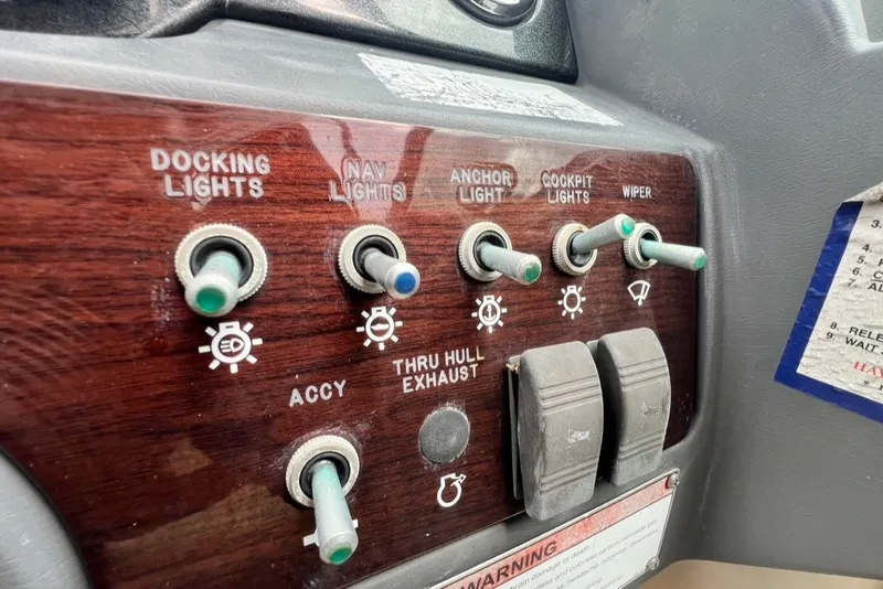 Slide: The Image of Control panel of a 2007 Sea Ray 260 Sundeck with various switches and labels. - 61