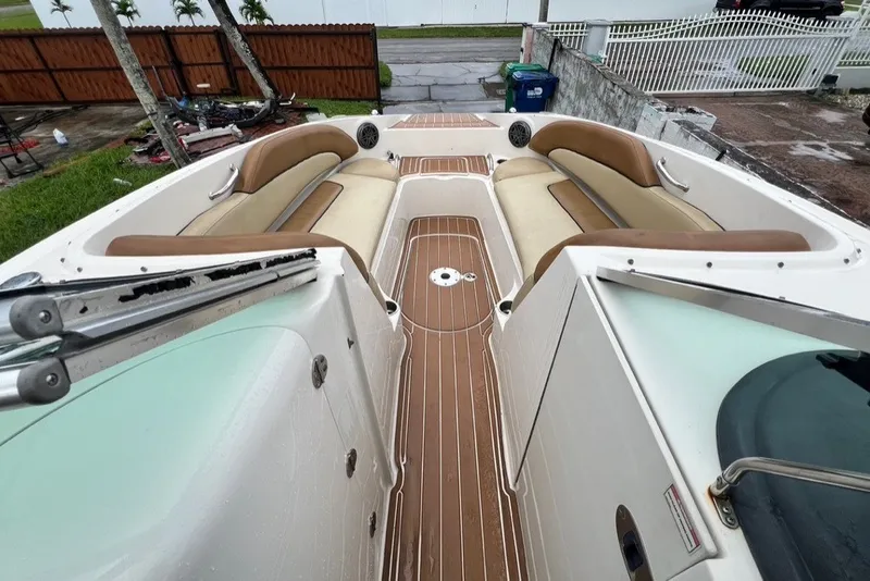 Slide: The Image of 2007 Sea Ray 260 Sundeck boat interior with tan seating and wood-style flooring. - 56
