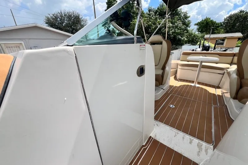 Slide: The Image of 2007 Sea Ray 260 Sundeck interior with seating and table, showcasing elegant design and comfort. - 39