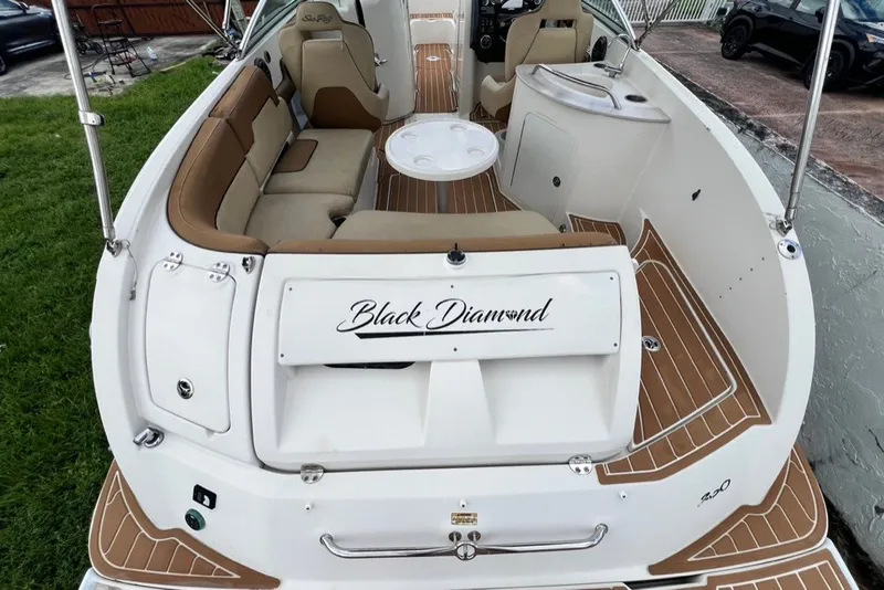 Slide: The Image of 2007 Sea Ray 260 Sundeck boat interior with seating and table, labeled "Black Diamond." - 80