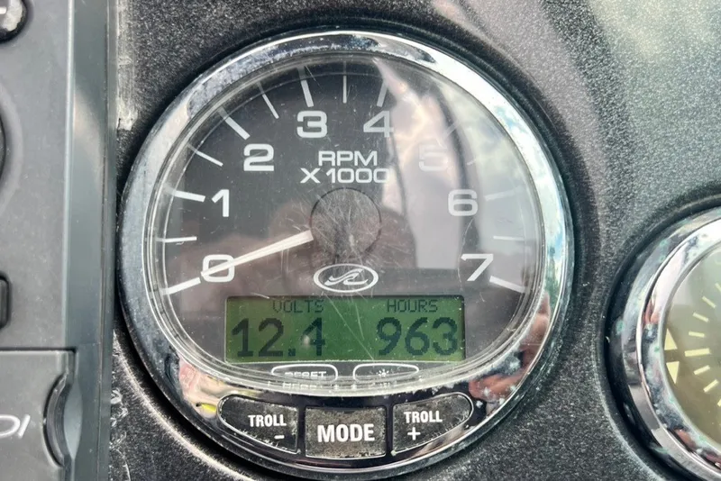 Slide: The Image of Close-up of a 2007 Sea Ray 260 Sundeck tachometer showing 963 hours and 12.4 volts. - 86