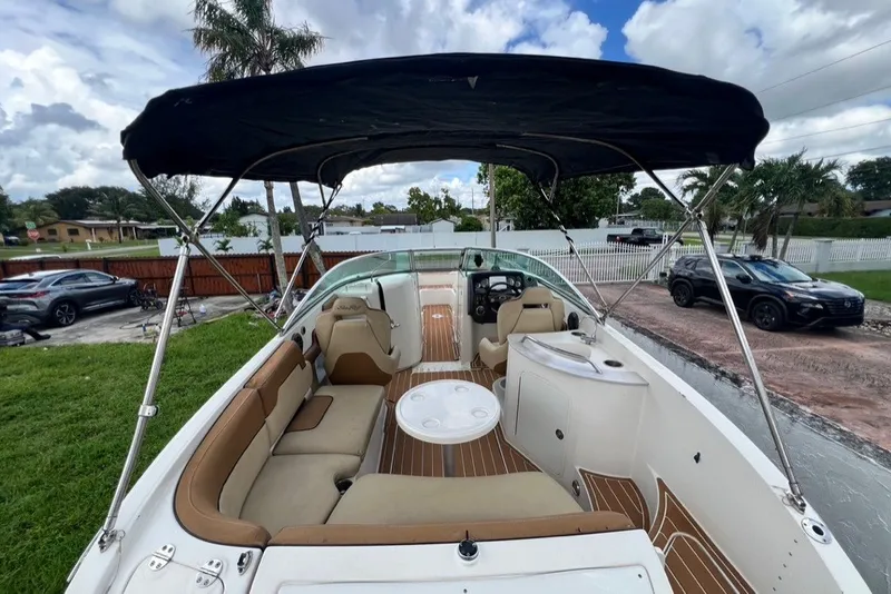 Slide: The Image of 2007 Sea Ray 260 Sundeck boat with canopy, spacious seating, and sleek design. - 81