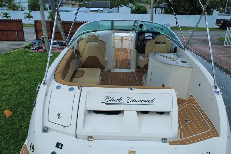 Slide: The Image of 2007 Sea Ray 260 Sundeck boat interior with seating and helm, named "Black Diamond." - 10