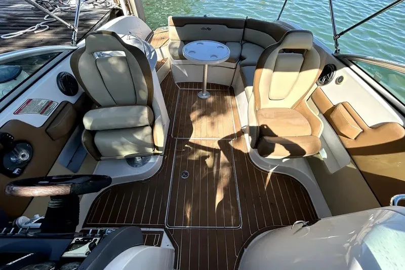 Slide: The Image of 2007 Sea Ray 260 Sundeck interior with seating and table on water. - 10