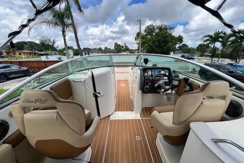 Slide: The Image of 2007 Sea Ray 260 Sundeck boat interior with helm, seating, and wood flooring. - 67