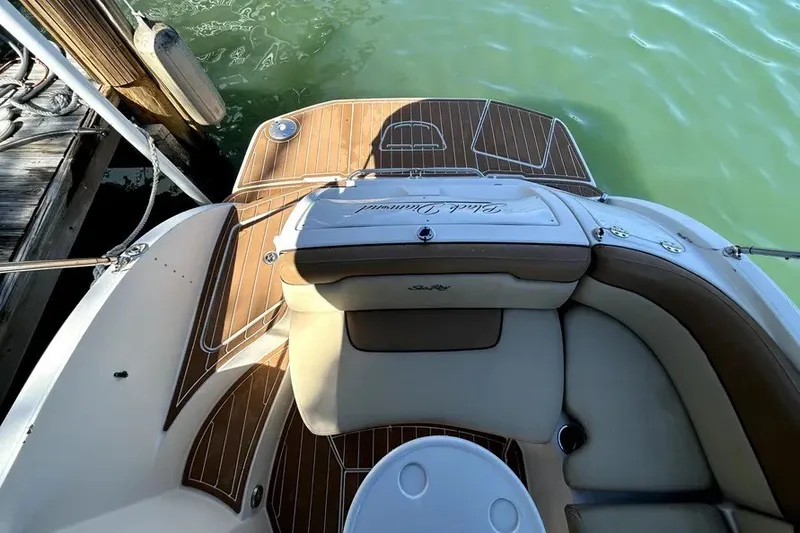 Slide: The Image of 2007 Sea Ray 260 Sundeck boat interior with teak flooring and cushioned seating. - 8