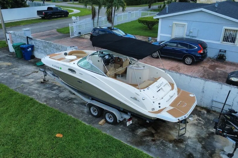 Slide: The Image of 2007 Sea Ray 260 Sundeck boat on trailer, parked in residential driveway. - 13