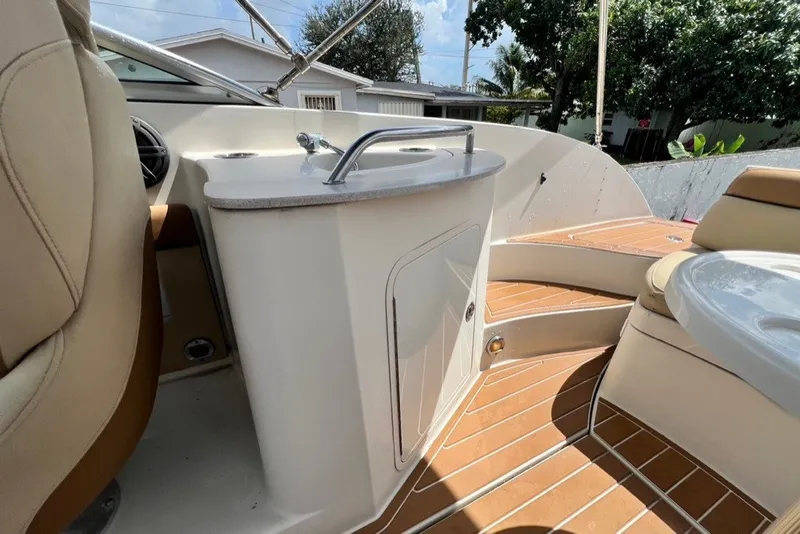 Slide: The Image of 2007 Sea Ray 260 Sundeck interior with seating and sink, showcasing luxury boat features. - 34