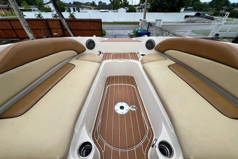 Slide: The Image of 2007 Sea Ray 260 Sundeck interior with tan seating and wood-style flooring. - 54