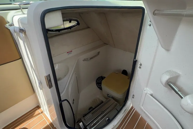 Slide: The Image of Interior view of a 2007 Sea Ray 260 Sundeck boat's compact bathroom area. - 15