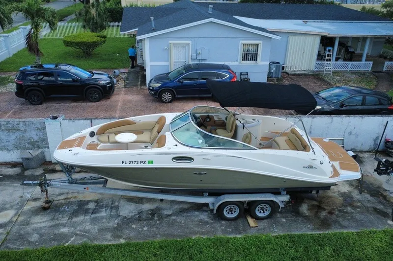 Slide: The Image of 2007 Sea Ray 260 Sundeck boat on trailer, parked in residential driveway. - 12