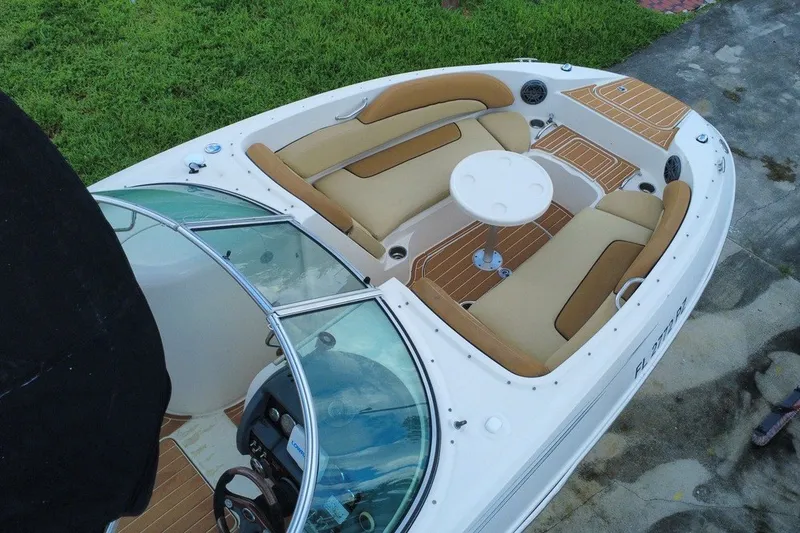 Slide: The Image of 2007 Sea Ray 260 Sundeck boat with tan seating and a round table on deck. - 3