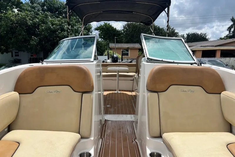 Slide: The Image of 2007 Sea Ray 260 Sundeck interior with tan seating and open deck view. - 44