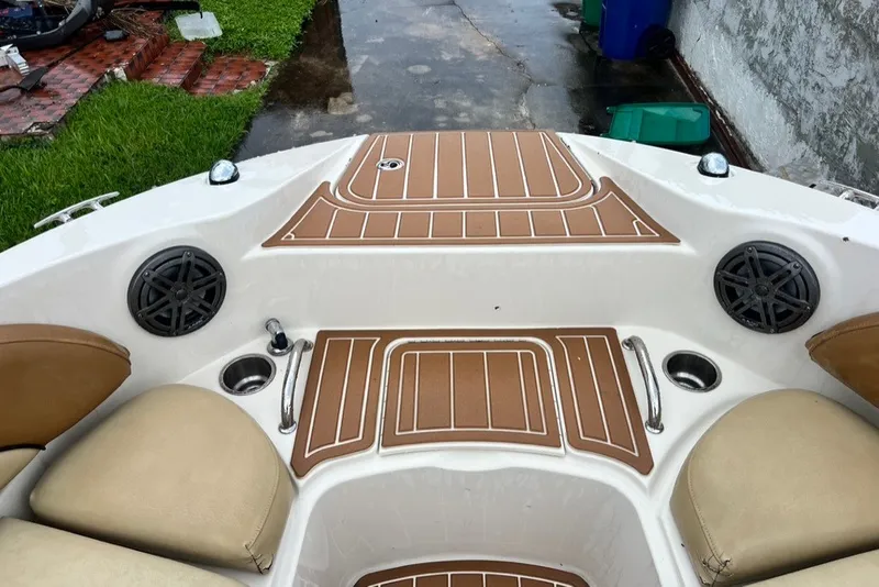 Slide: The Image of 2007 Sea Ray 260 Sundeck interior with cushioned seating and marine speakers. - 52