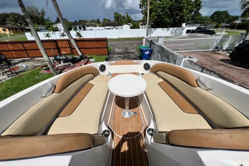 Slide: The Image of 2007 Sea Ray 260 Sundeck boat interior with tan seating and round table. - 24