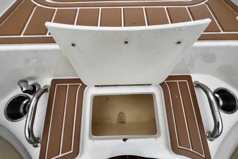 Slide: The Image of 2007 Sea Ray 260 Sundeck boat deck with storage compartment and cup holders. - 51