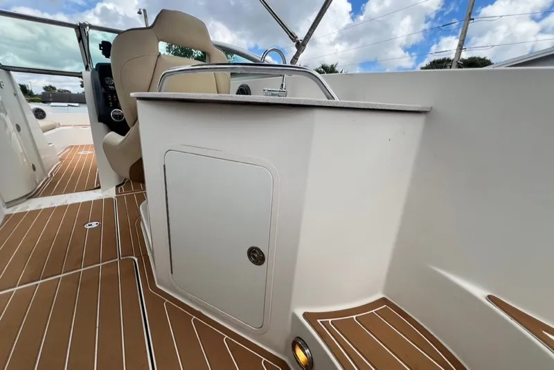 Slide: The Image of 2007 Sea Ray 260 Sundeck interior with seating and storage, featuring teak-style flooring. - 71
