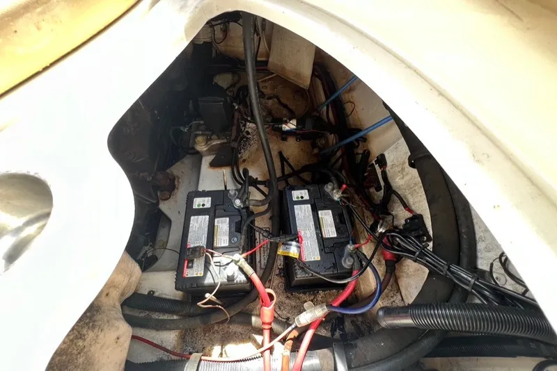 Slide: The Image of 2007 Sea Ray 260 Sundeck engine compartment with dual batteries and wiring. - 26