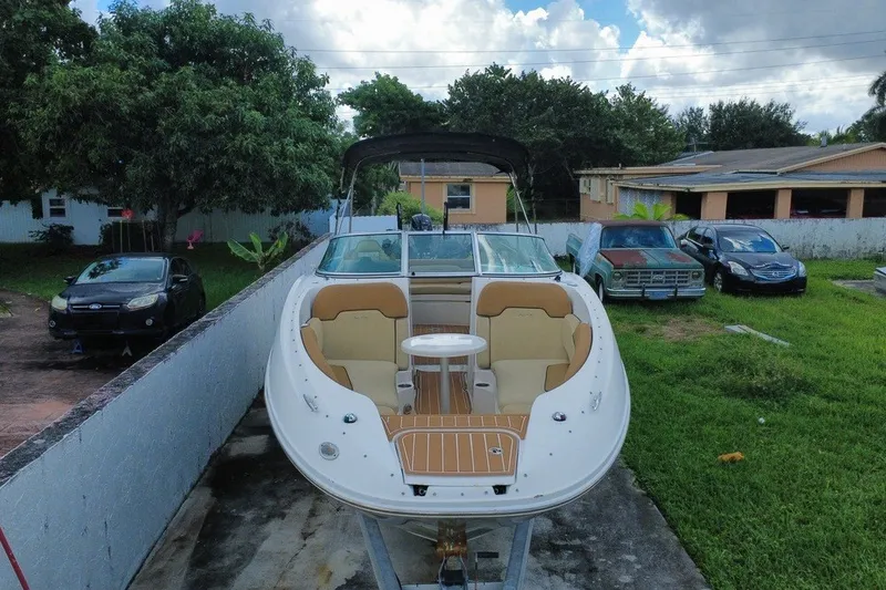 Slide: The Image of 2007 Sea Ray 260 Sundeck boat on trailer, parked in residential driveway. - 8