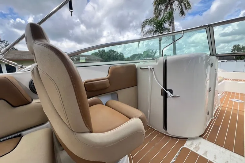 Slide: The Image of 2007 Sea Ray 260 Sundeck interior with tan seating and sleek design. - 64