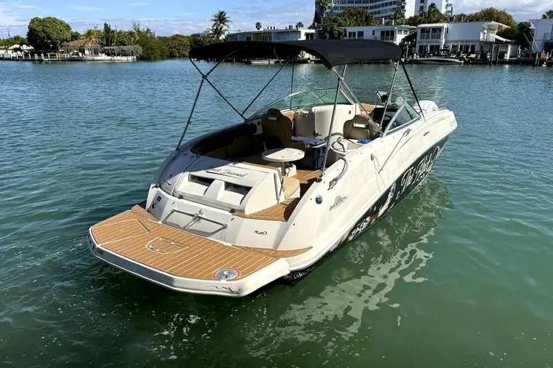 Slide: The Image of 2007 Sea Ray 260 Sundeck boat on calm water, featuring a sleek design and canopy. - 5