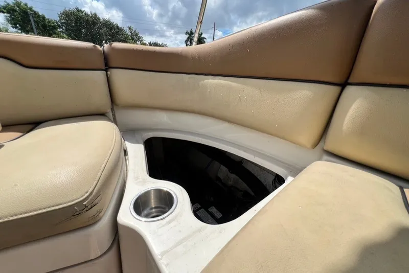 Slide: The Image of 2007 Sea Ray 260 Sundeck interior seating with cup holder and storage compartment. - 27