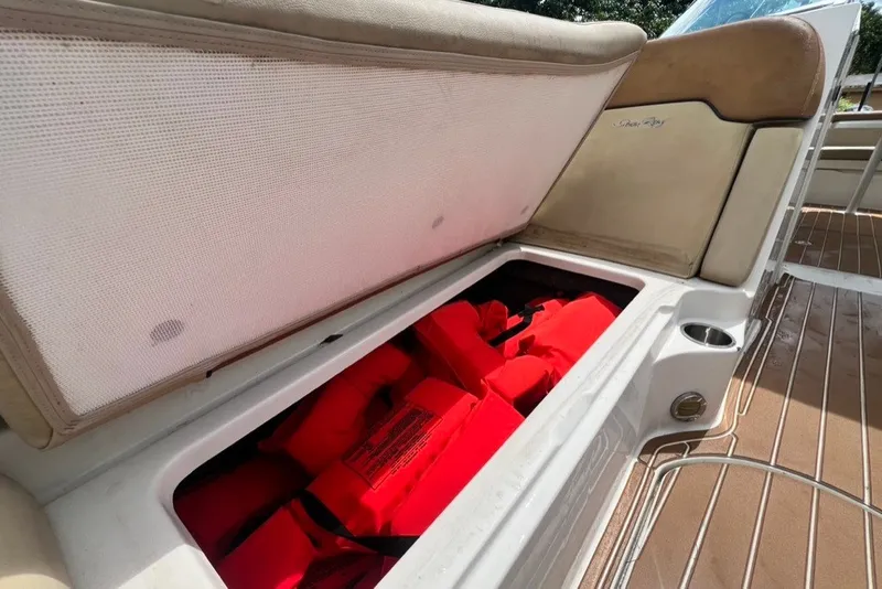 Slide: The Image of Open storage compartment on 2007 Sea Ray 260 Sundeck with red life jackets inside. - 43