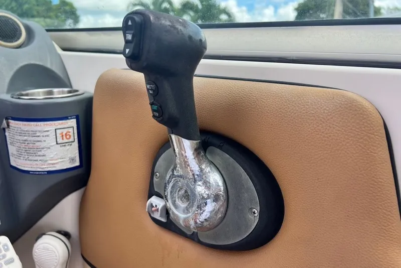 Slide: The Image of Throttle control lever on a 2007 Sea Ray 260 Sundeck boat dashboard. - 83