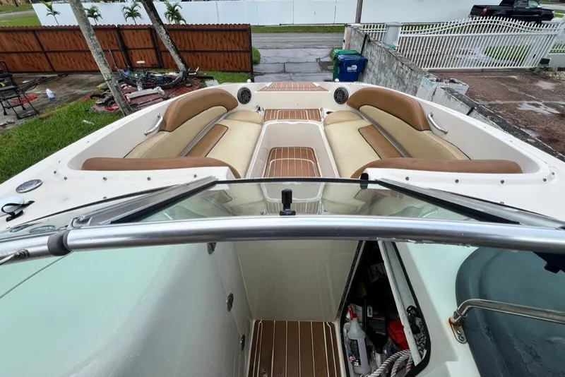 Slide: The Image of 2007 Sea Ray 260 Sundeck boat interior with tan seating and wood accents. - 57