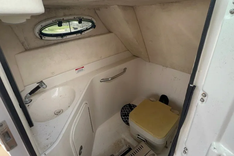 Slide: The Image of 2007 Sea Ray 260 Sundeck interior bathroom with sink and portable toilet. - 16