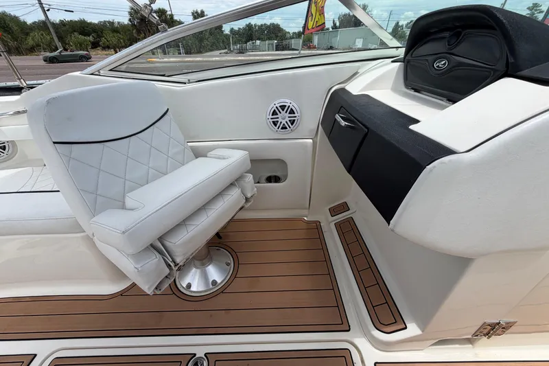 Slide: The Image of 2007 Sea Ray SLX 250 boat interior with white seating and wood flooring. - 57