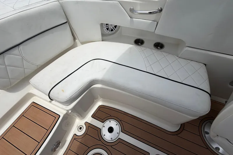 Slide: The Image of White leather seating on 2007 Sea Ray SLX 250 boat with teak flooring. - 67