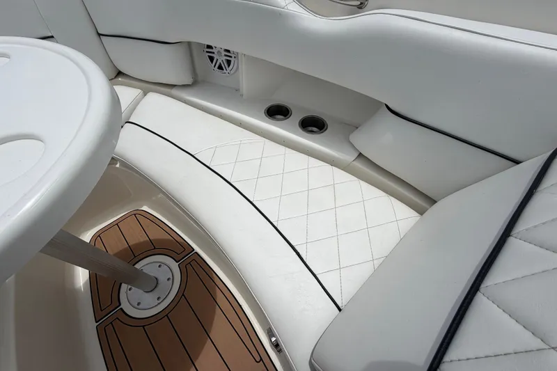 Slide: The Image of Luxurious interior of 2007 Sea Ray SLX 250 boat with white seating and wood accents. - 51