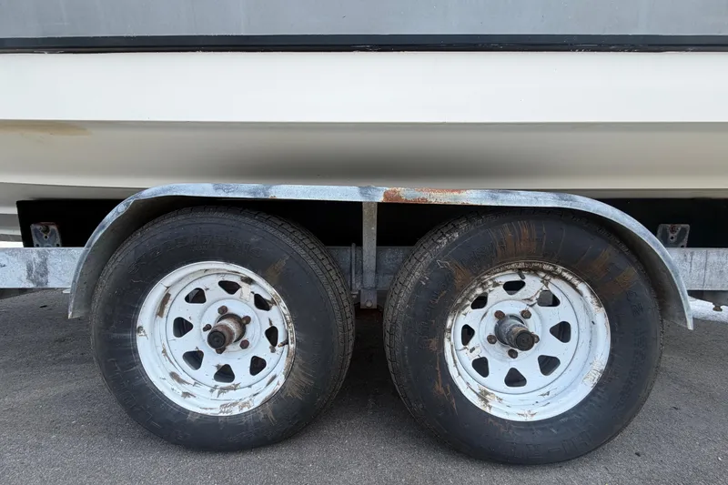 Slide: The Image of Trailer wheels of a 2007 Sea Ray SLX 250 boat on pavement. - 82
