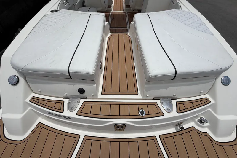 Slide: The Image of 2007 Sea Ray SLX 250 boat interior with white seating and teak flooring. - 15