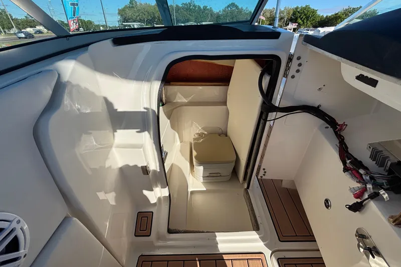 Slide: The Image of Interior view of 2007 Sea Ray SLX 250 boat cabin with seating and storage. - 64