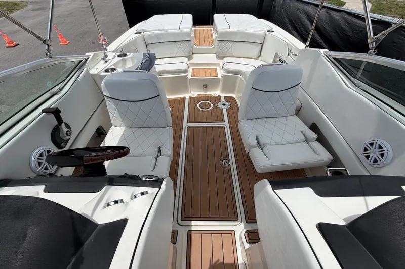 Slide: The Image of 2007 Sea Ray SLX 250 boat interior with white seating and wood flooring. - 55
