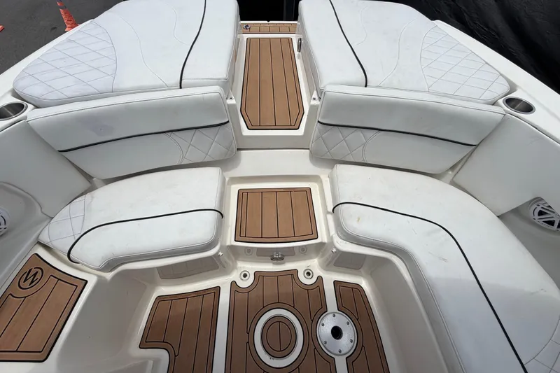 Slide: The Image of Luxurious 2007 Sea Ray SLX 250 boat interior with white cushioned seating and teak flooring. - 70