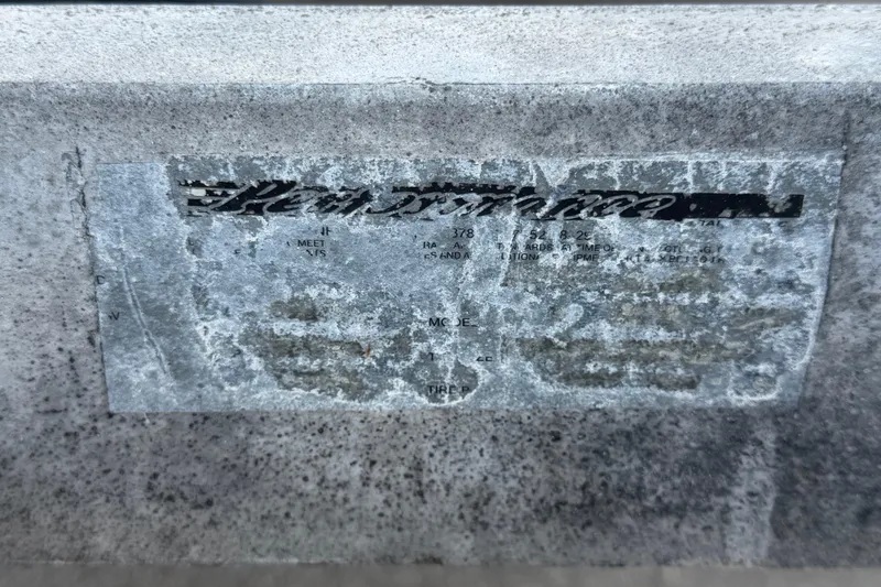 Slide: The Image of Faded label on a 2007 Sea Ray SLX 250 boat, showing wear and text erosion. - 84